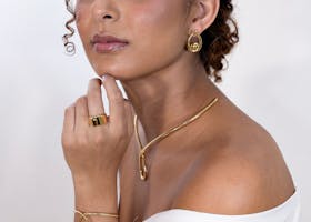 Stunning portrait of a woman with gold jewelry, radiating elegance and beauty.